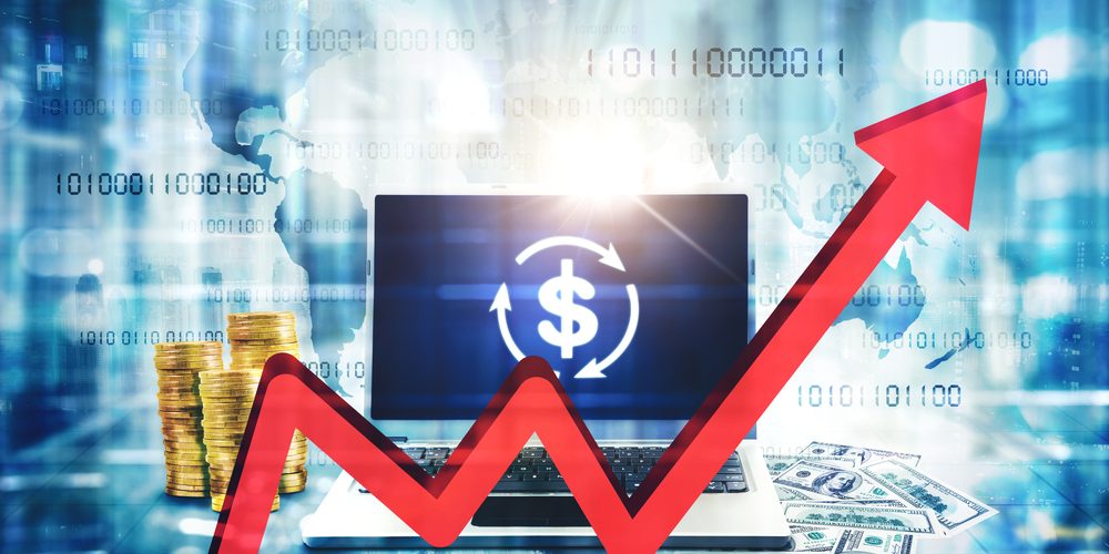 Close,Up,Of,Red,Upward,Arrow,With,Laptop,And,Money
