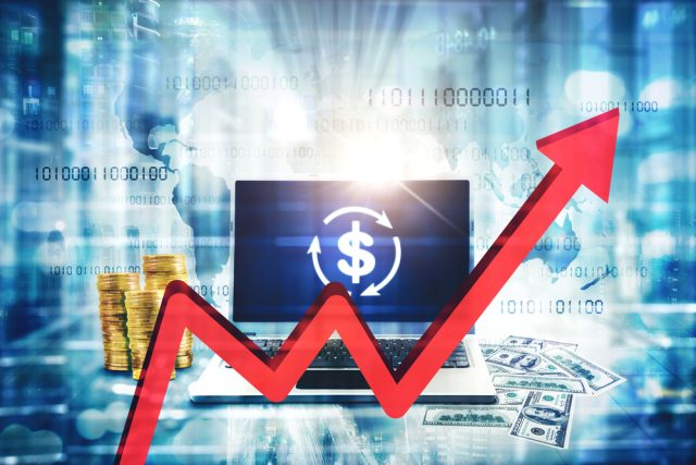 Close,Up,Of,Red,Upward,Arrow,With,Laptop,And,Money